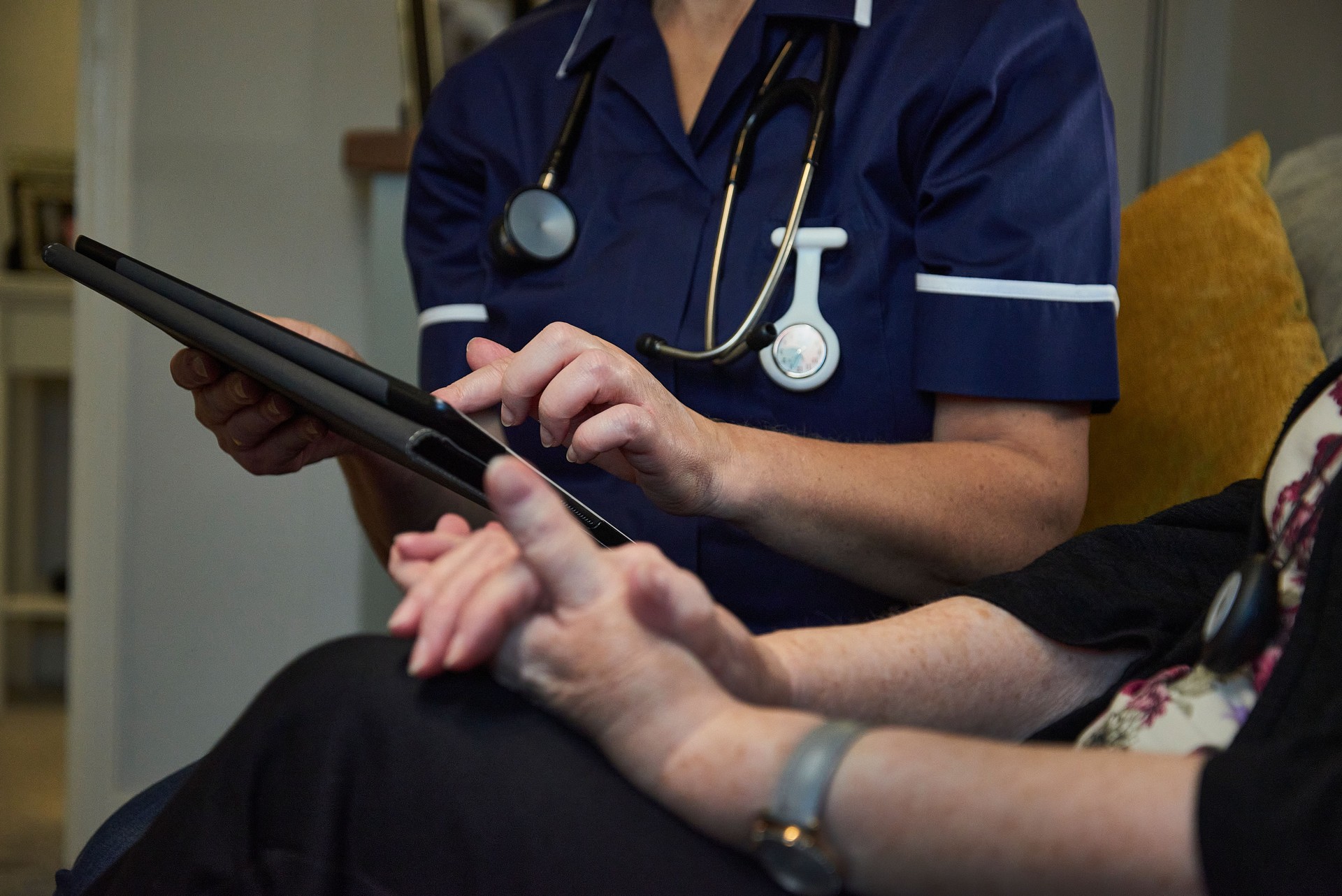 Nurse taking notes on senior patient
